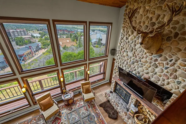 a living room with furniture and a floor to ceiling window