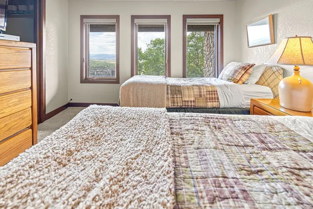 a bed sitting in a bedroom next to a window