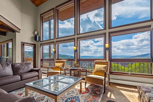 a view of a patio with table and chairs with wooden floor and fence