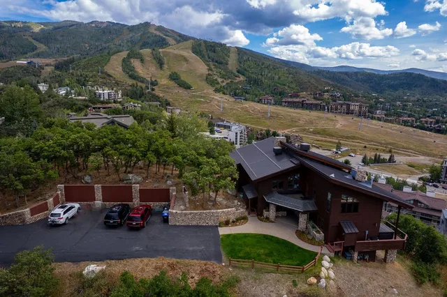 a bathroom with a sink a mirror and wooden floor