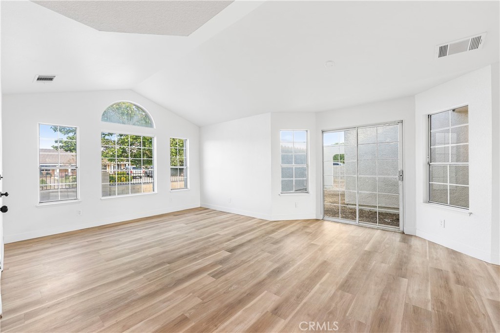 40251 Fieldspring Street Palmdale, CA 93591 - Photo 13 of 45 a view of an empty room with a window and wooden floor