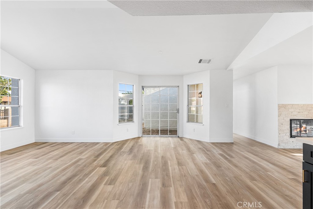 40251 Fieldspring Street Palmdale, CA 93591 - Photo 15 of 45 a view of an empty room with wooden floor and a window