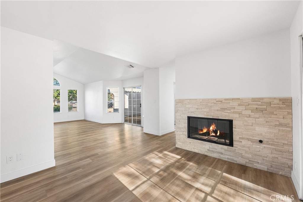 40251 Fieldspring Street Palmdale, CA 93591 - Photo 18 of 45 a view of an empty room with wooden floor fireplace and a window