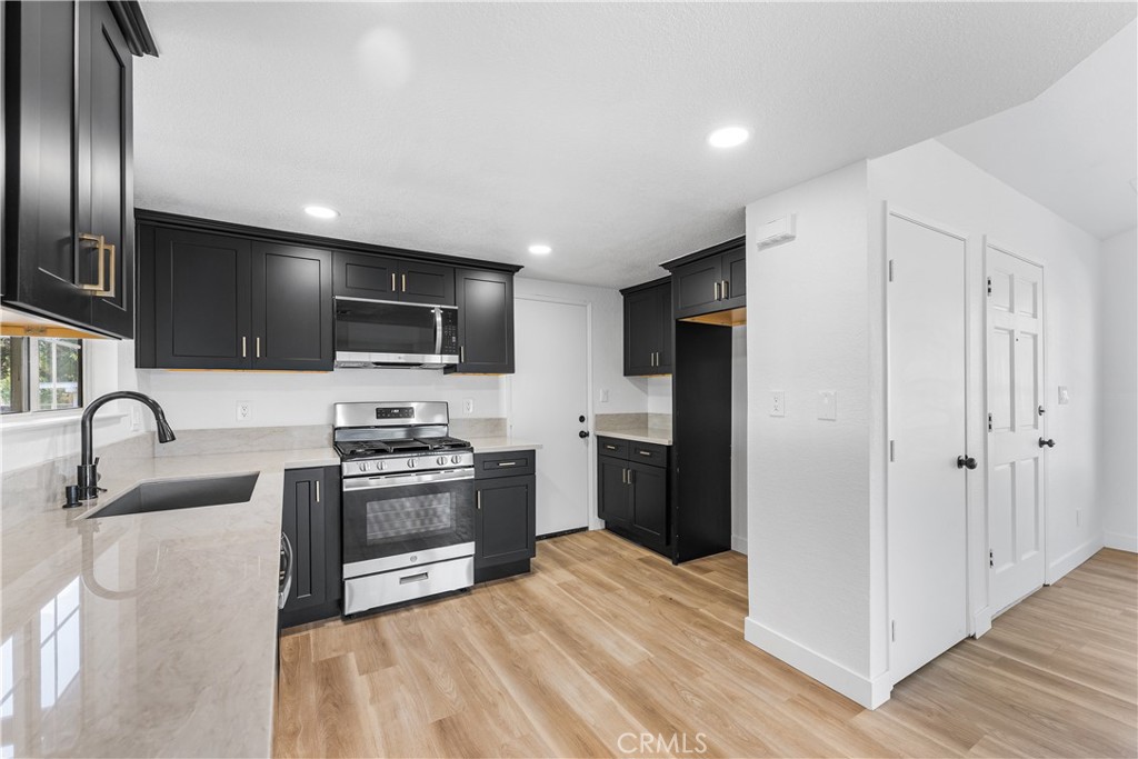 40251 Fieldspring Street Palmdale, CA 93591 - Photo 21 of 45 a kitchen with stainless steel appliances granite countertop a refrigerator a sink a stove and oven