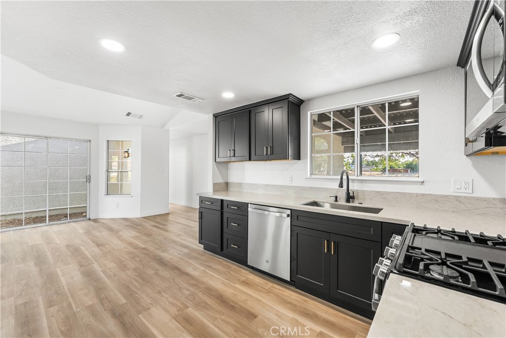 40251 Fieldspring Street Palmdale, CA 93591 - Photo 23 of 45 a kitchen with stainless steel appliances granite countertop a sink stove and refrigerator