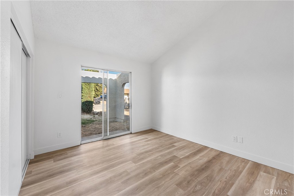 40251 Fieldspring Street Palmdale, CA 93591 - Photo 26 of 45 an empty room with wooden floor and windows