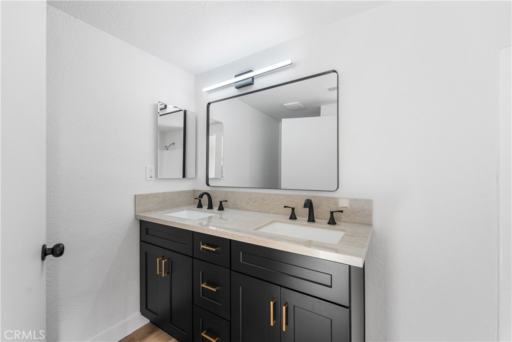 40251 Fieldspring Street Palmdale, CA 93591 - Photo 33 of 45 a bathroom with a double vanity sink and mirror