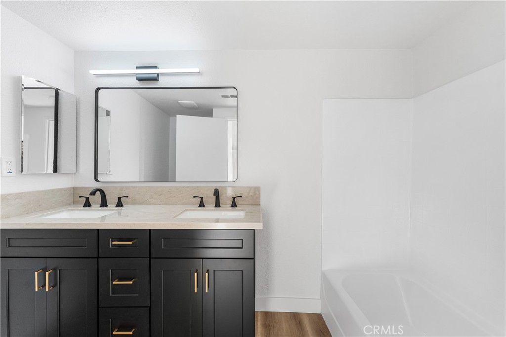 40251 Fieldspring Street Palmdale, CA 93591 - Photo 34 of 45 a bathroom with a double vanity sink and a mirror