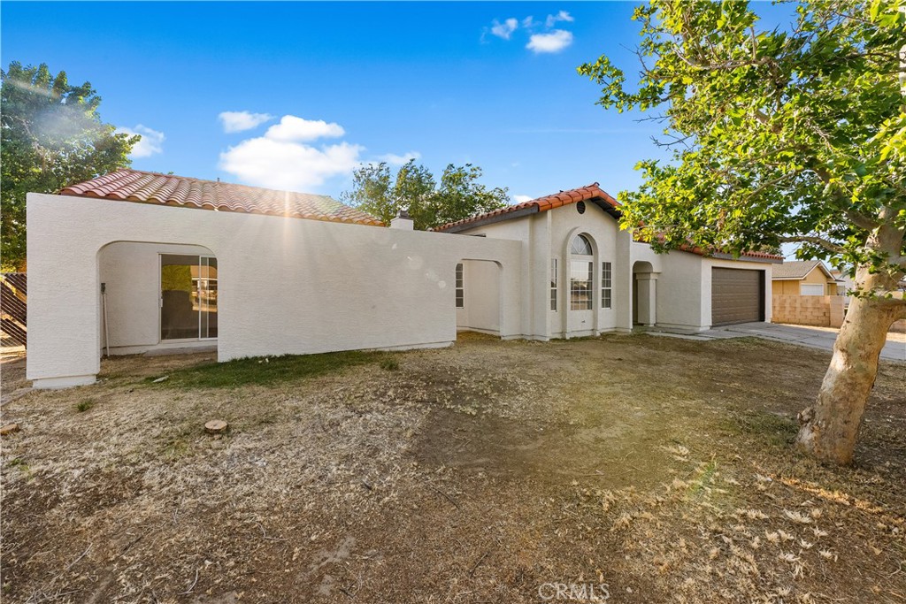40251 Fieldspring Street Palmdale, CA 93591 - Photo 4 of 45 a view of a house with a backyard