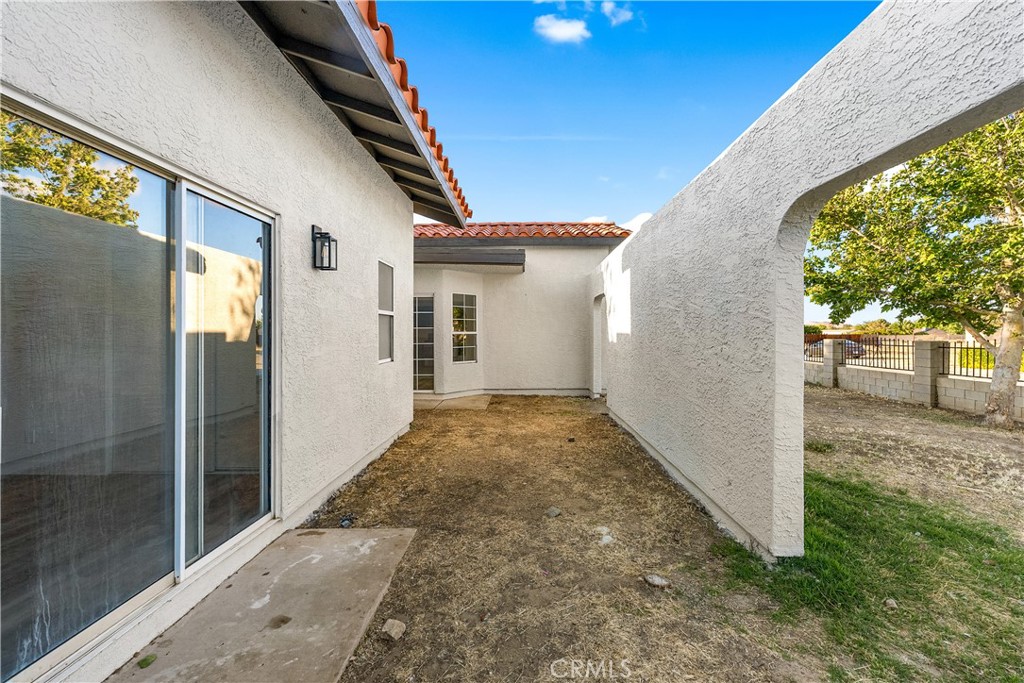 40251 Fieldspring Street Palmdale, CA 93591 - Photo 8 of 45 a view of a porch with a backyard