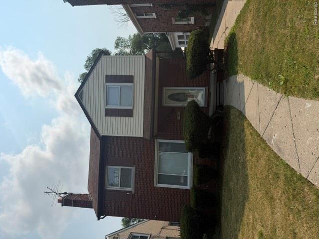 8144 Meyers Road Detroit, MI 48228 - Photo 1 of 19 Brick and siding exterior with a prominent front entrance, concrete walkway, established front landscaping, and a side driveway