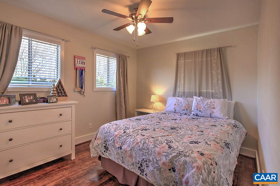 402 Harris Road Charlottesville, VA 22903 - Photo 17 of 17 a bedroom with a bed and a dresser