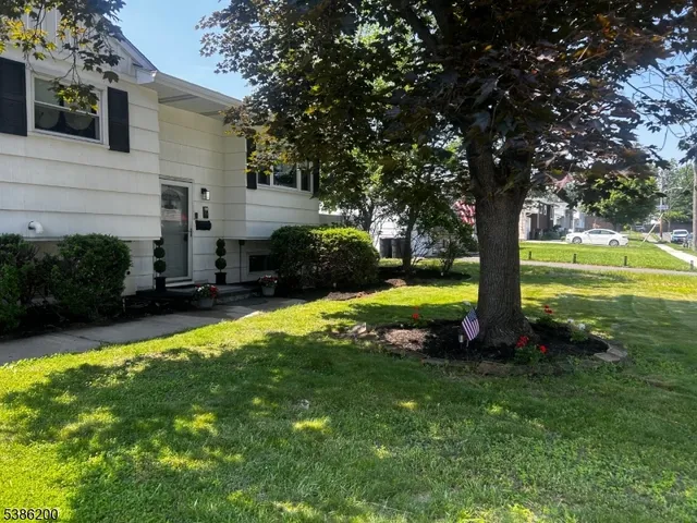 a view of a house with a yard porch and sitting area