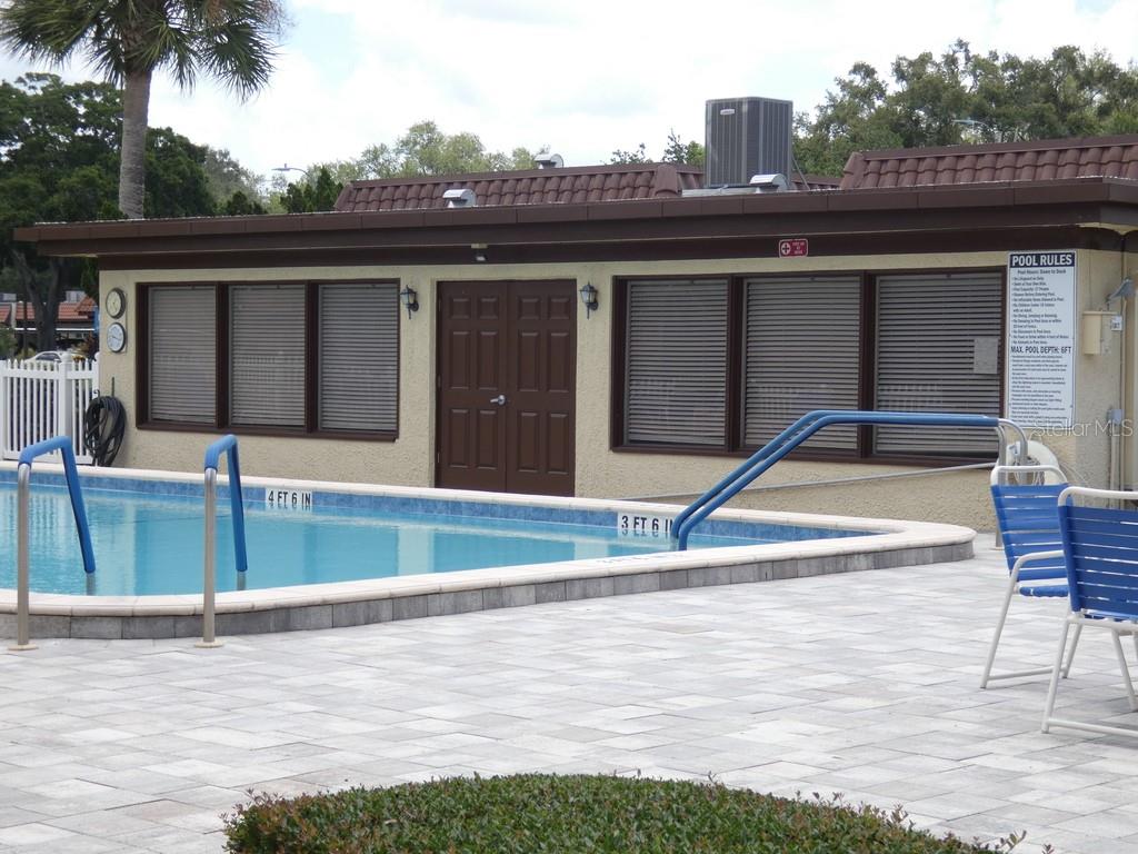 1701 Pinehurst Road, Unit 9G Dunedin, FL 34698 - Photo 20 of 22 a view of a patio with a table and chairs