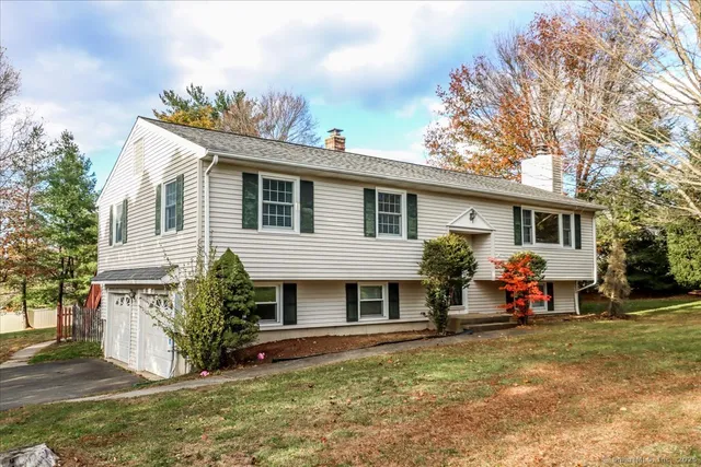 a front view of a house with a yard and a porch