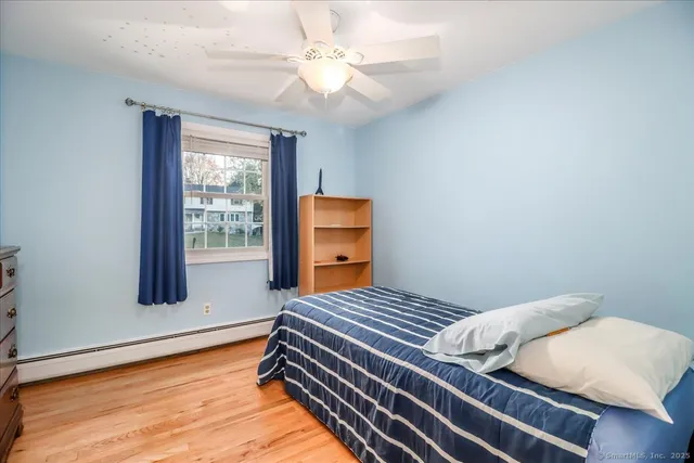 a bedroom with bed and balcony