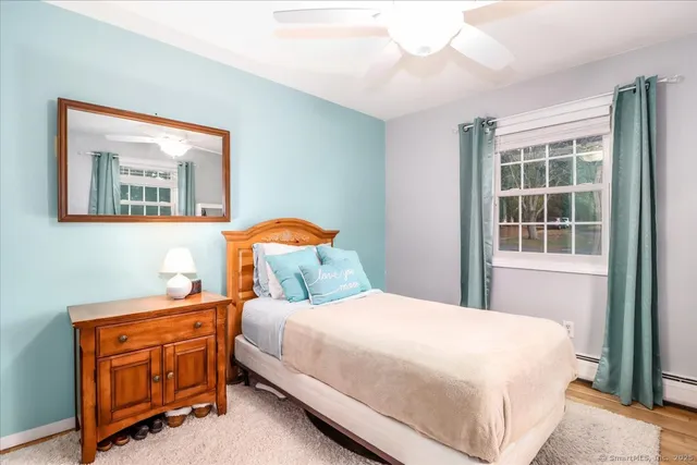 a bedroom with a bed and large window