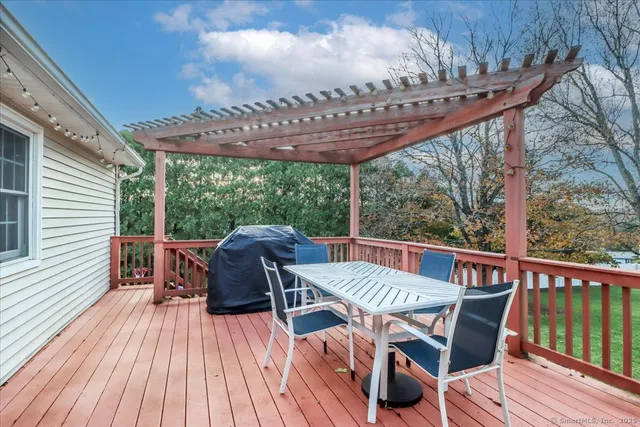 a view of a chair and table on the deck