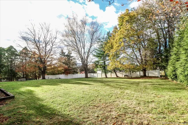 a view of a house with a yard and sitting area