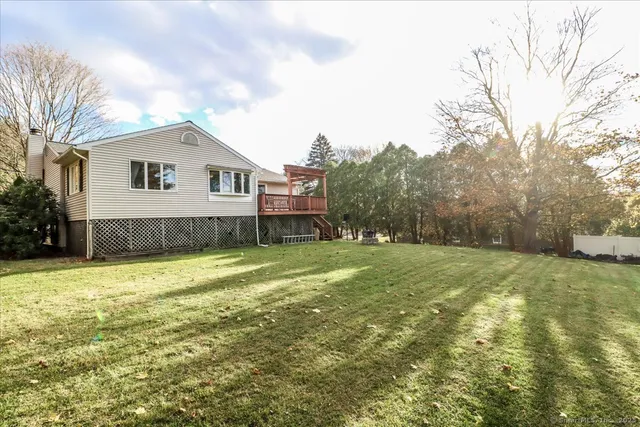 a view of a house with a yard and sitting area