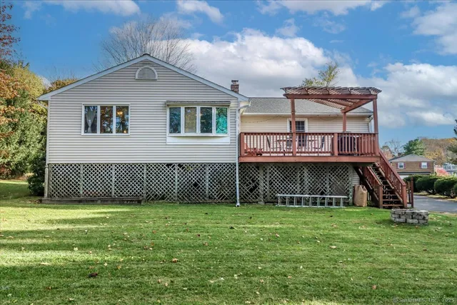 a view of a house with a yard and furniture