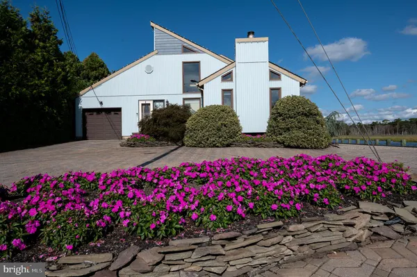 a view of a house with a lot of flower plants
