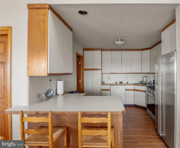 a kitchen with a sink a stove and cabinets