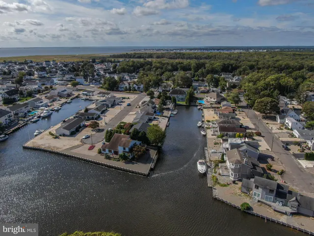 a view of a house with a yard and wooden fence