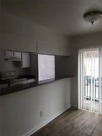 a kitchen with stainless steel appliances a sink stove and cabinets