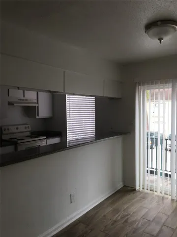 a kitchen with stainless steel appliances a sink stove and cabinets
