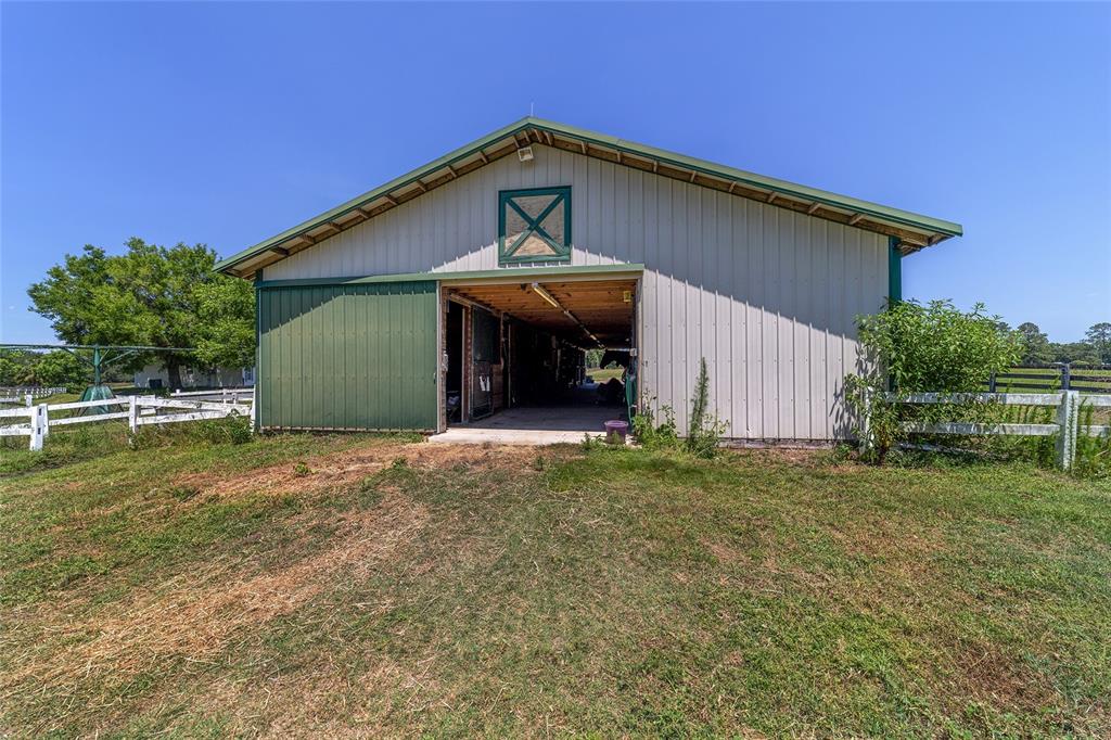 16490 Northwest 122nd Terrace Reddick, FL 32686 - Photo 18 of 24 a front view of a house with a garden