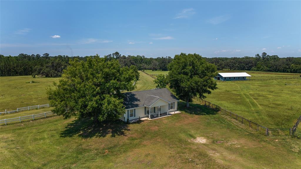 16490 Northwest 122nd Terrace Reddick, FL 32686 - Photo 6 of 24 a view of a lake with houses in the back
