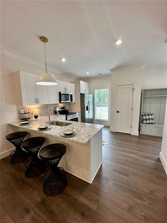 105 Chateau Drive Southeast Rome, GA 30161 - Photo 19 of 49 a open kitchen with kitchen island a stove a sink dishwasher and a dining table with wooden floor
