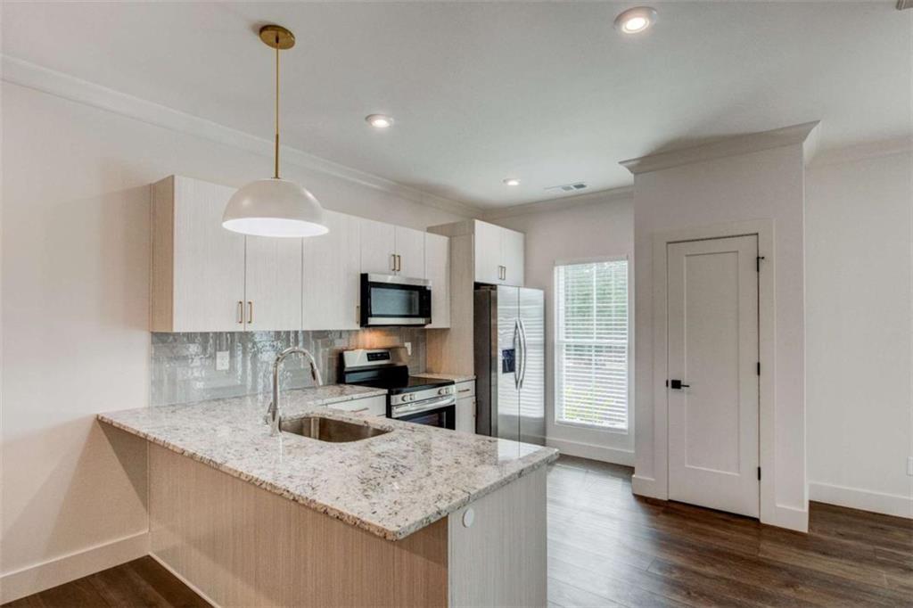 105 Chateau Drive Southeast Rome, GA 30161 - Photo 20 of 49 a kitchen with stainless steel appliances granite countertop a sink a stove a refrigerator a center island and wooden floor