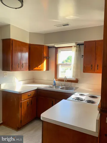 a kitchen with a sink cabinets and window
