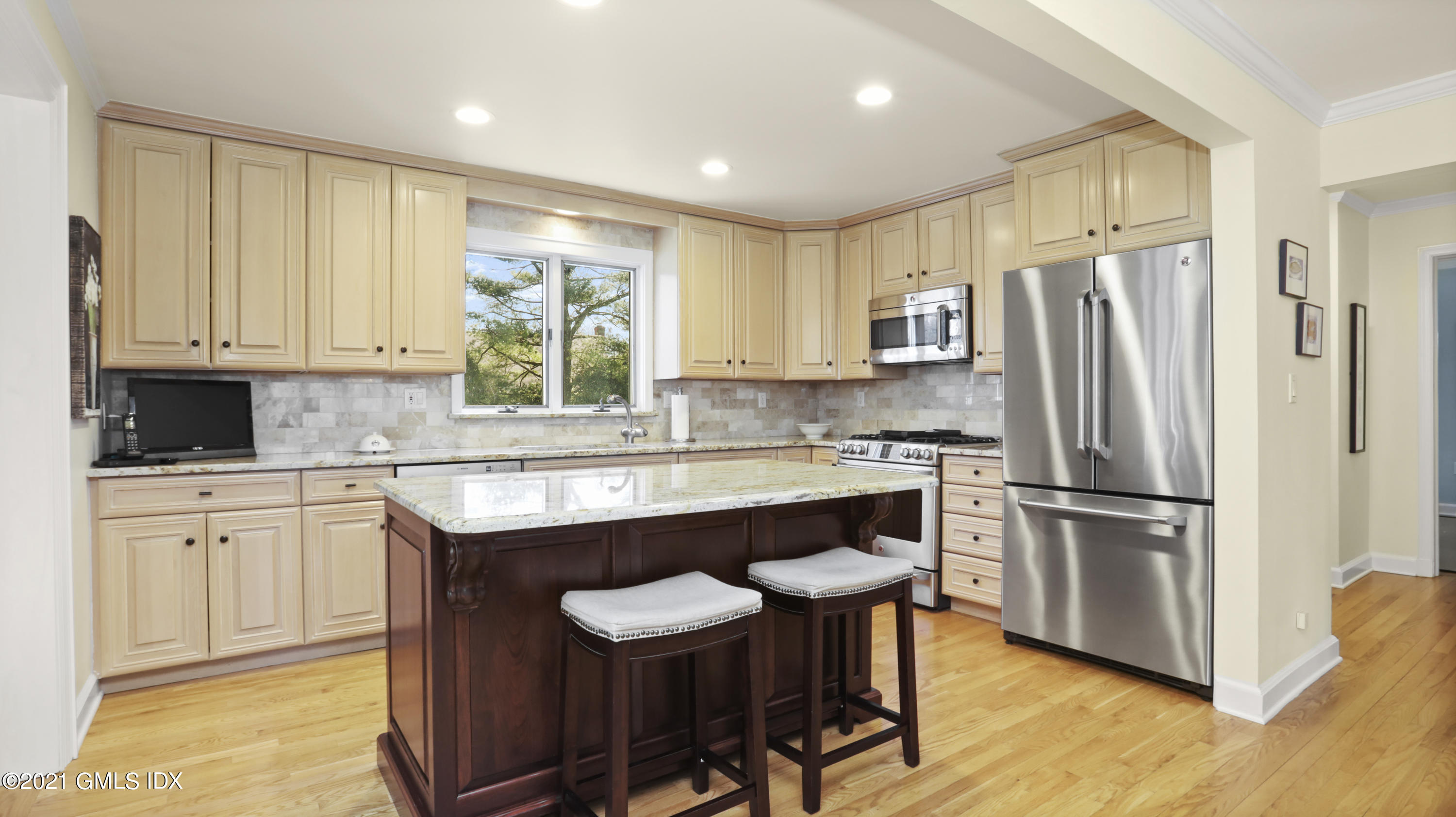 4 Norias Road Greenwich, CT 06830 - Photo 16 of 44 a kitchen with stainless steel appliances granite countertop a stove a sink a refrigerator and white cabinets with wooden floor