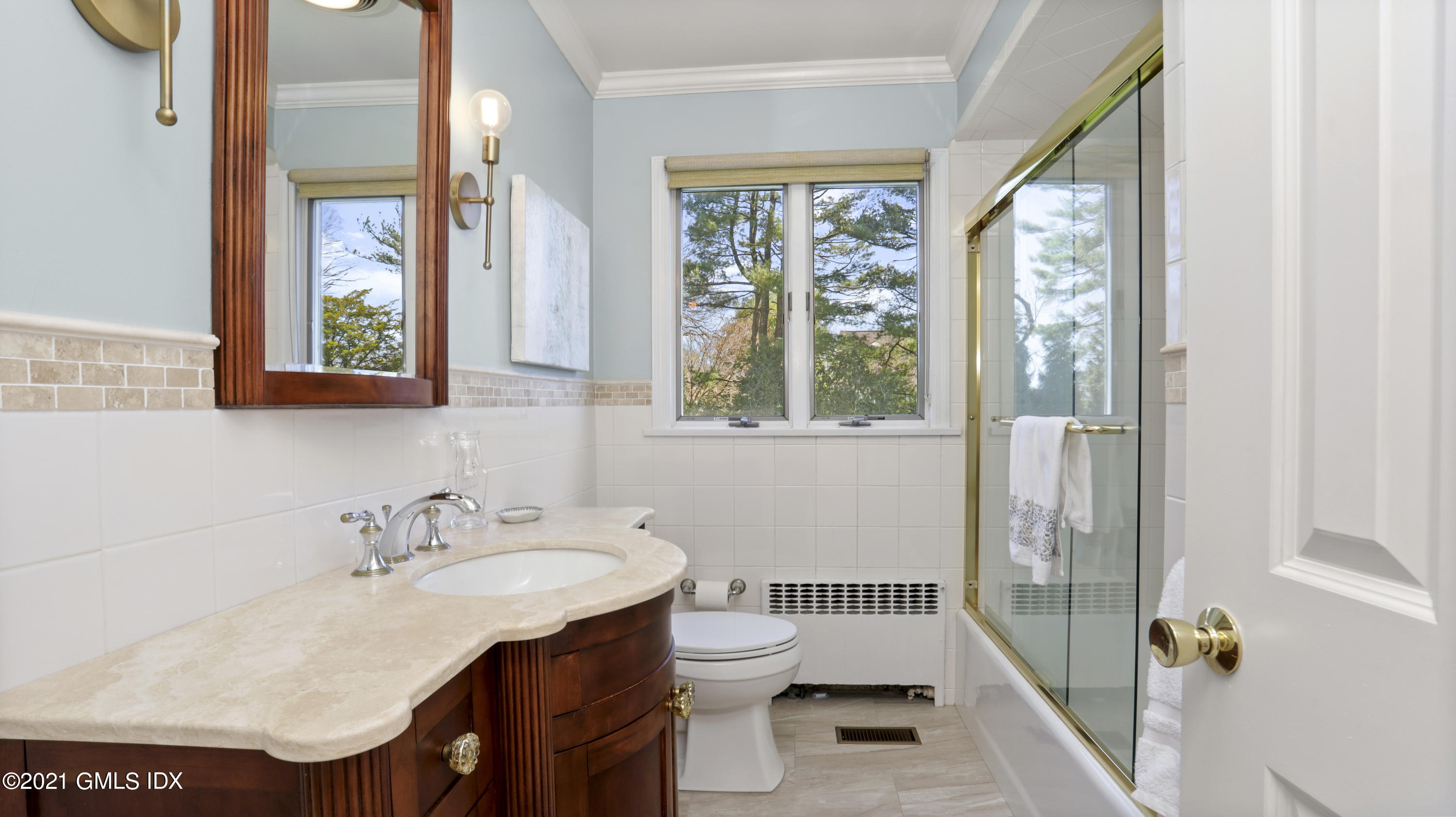 4 Norias Road Greenwich, CT 06830 - Photo 25 of 44 a bathroom with a sink and a mirror