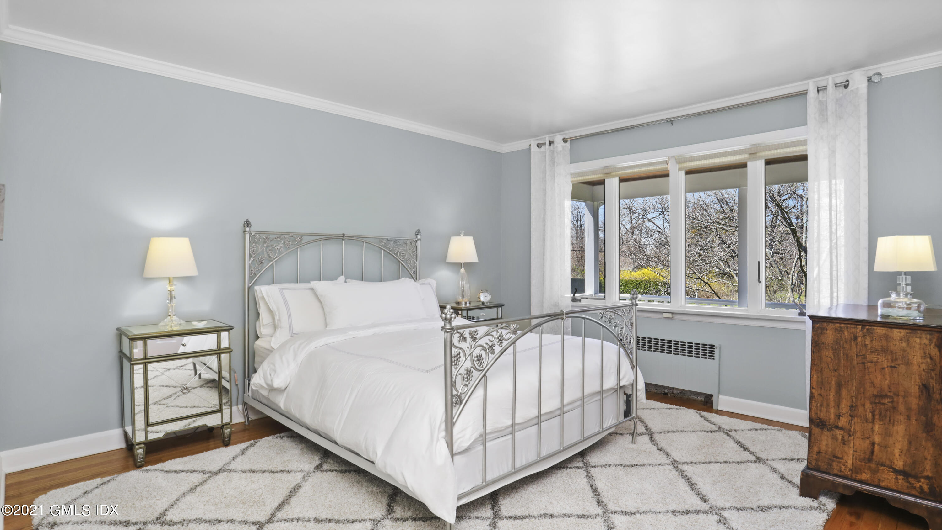 4 Norias Road Greenwich, CT 06830 - Photo 26 of 44 a bedroom with a bed and a table in it