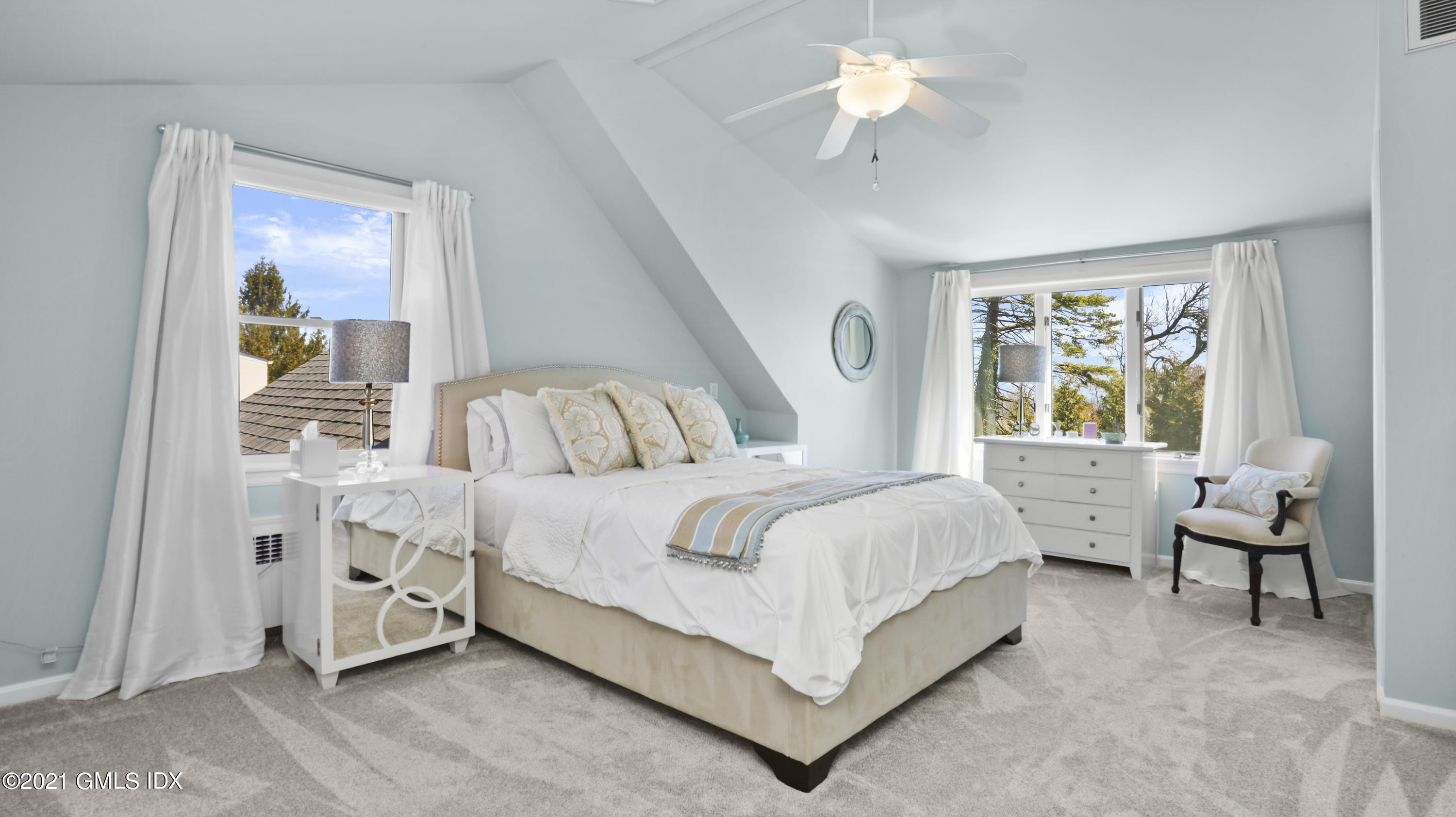 4 Norias Road Greenwich, CT 06830 - Photo 27 of 44 a bedroom with a bed and a chandelier