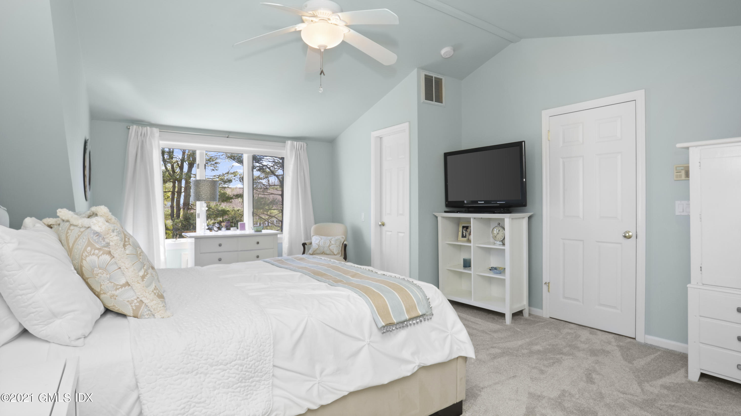 4 Norias Road Greenwich, CT 06830 - Photo 28 of 44 a spacious bedroom with a large bed and a flat tv screen on dresser