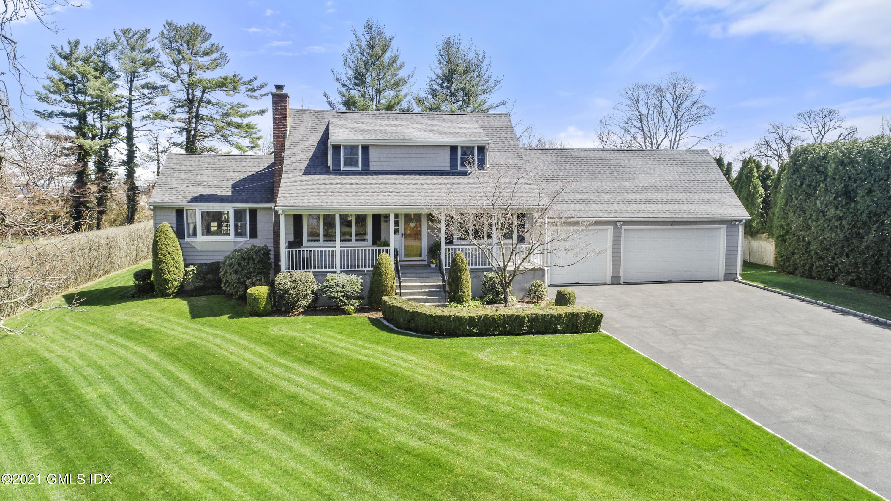 4 Norias Road Greenwich, CT 06830 - Photo 3 of 44 a front view of a house with a garden and yard