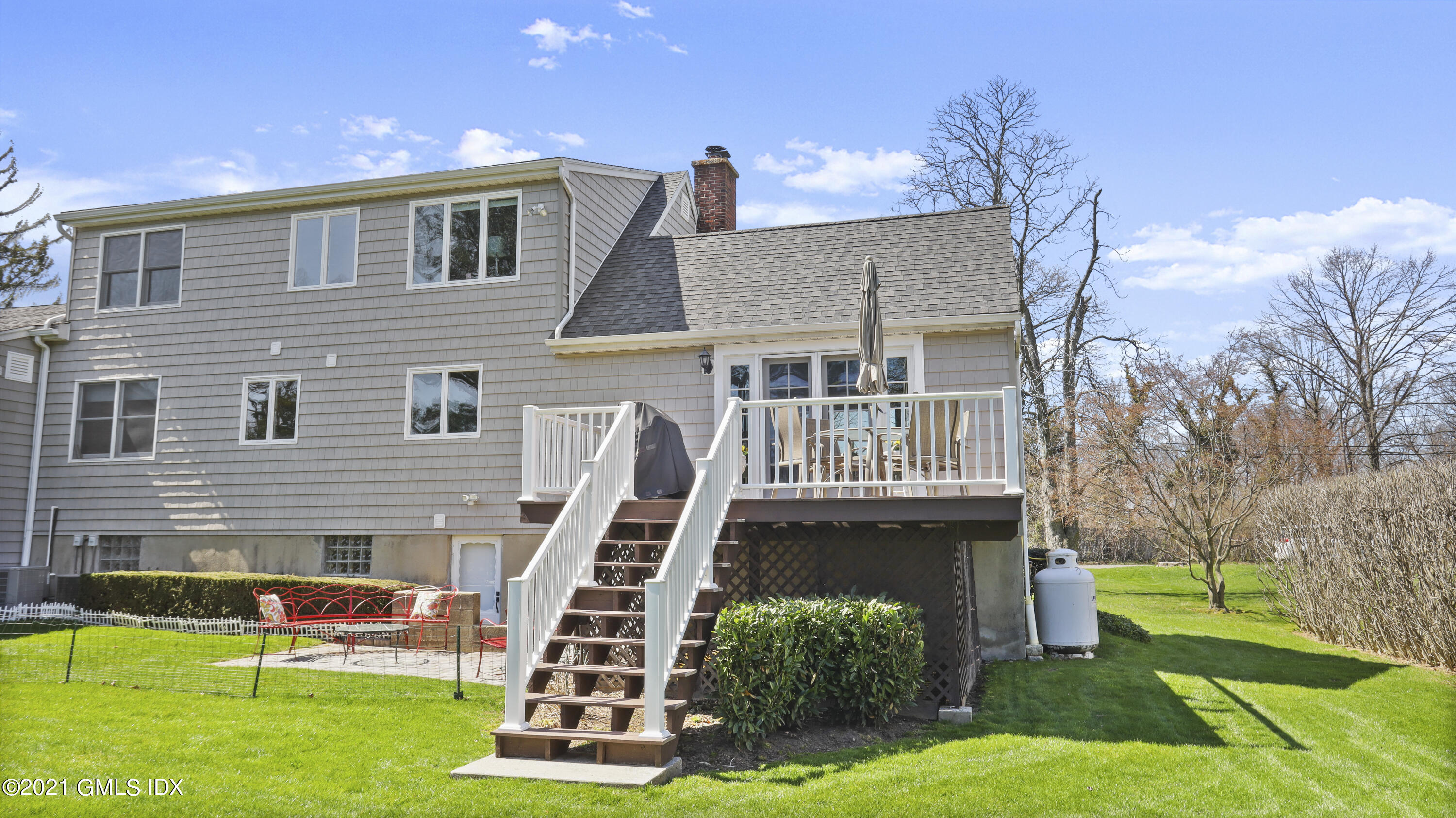 4 Norias Road Greenwich, CT 06830 - Photo 37 of 44 a front view of a house with a yard