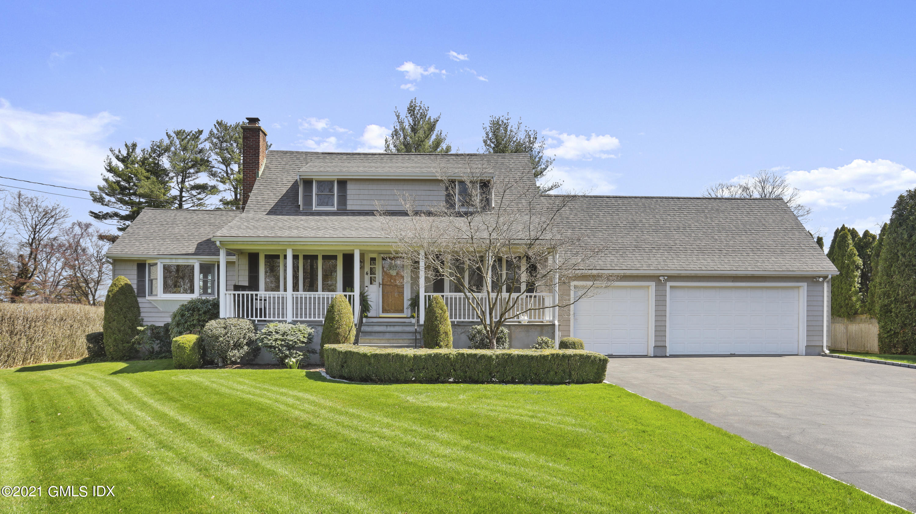 4 Norias Road Greenwich, CT 06830 - Photo 43 of 44 a front view of a house with a garden and yard
