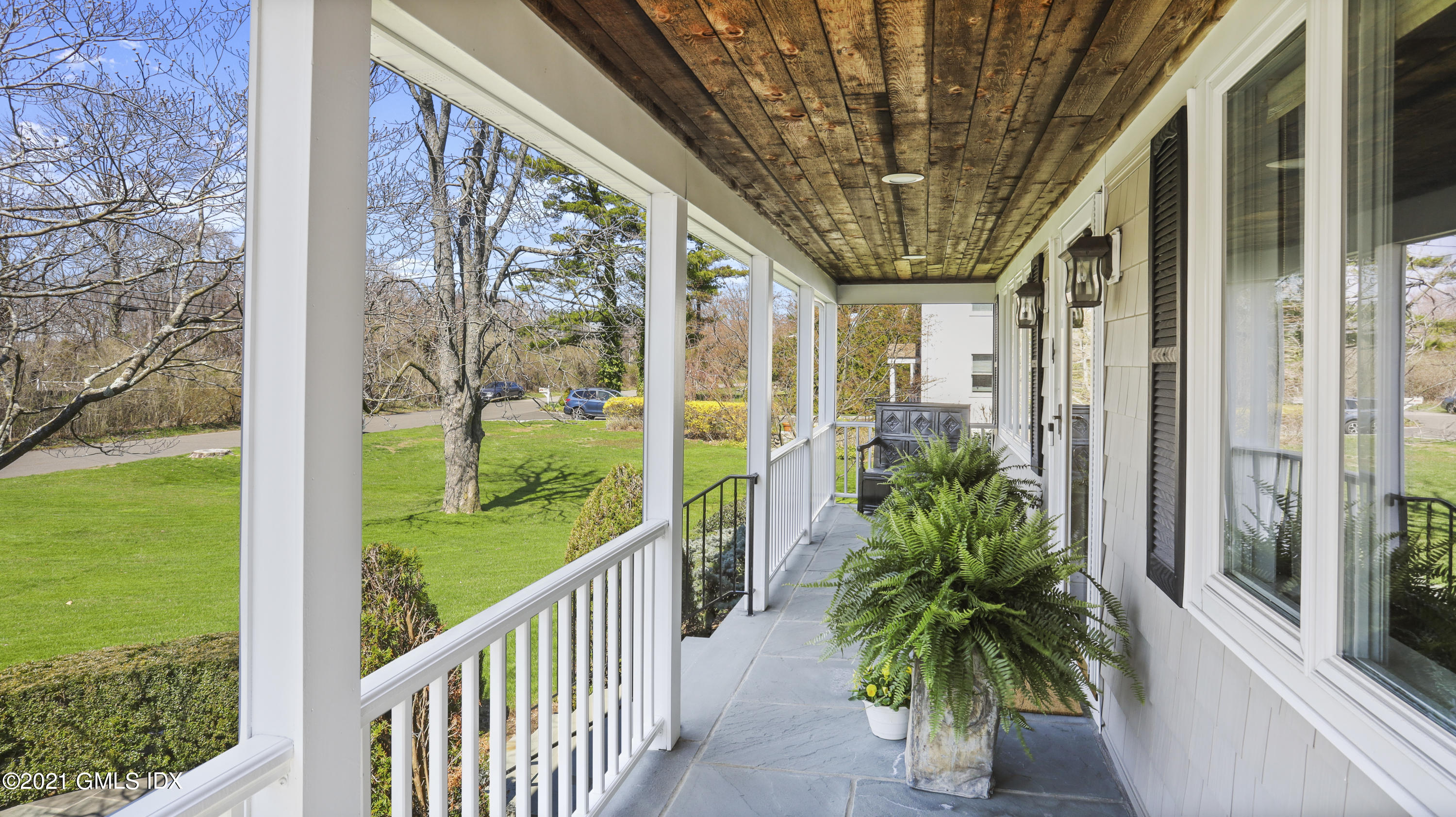 4 Norias Road Greenwich, CT 06830 - Photo 8 of 44 a porch with a fountain in front of a yard