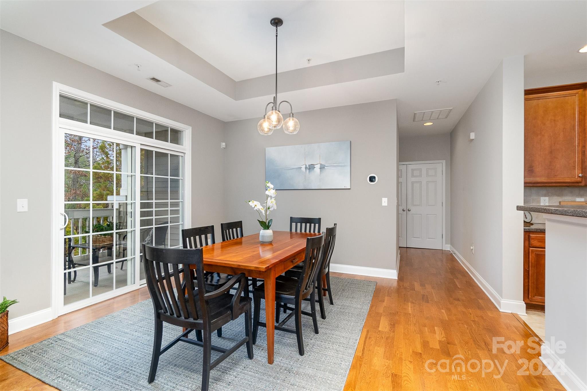 8653 Edinburgh Square Drive Cornelius, NC 28031 - Photo 13 of 22 a dining room with a wooden table and chairs