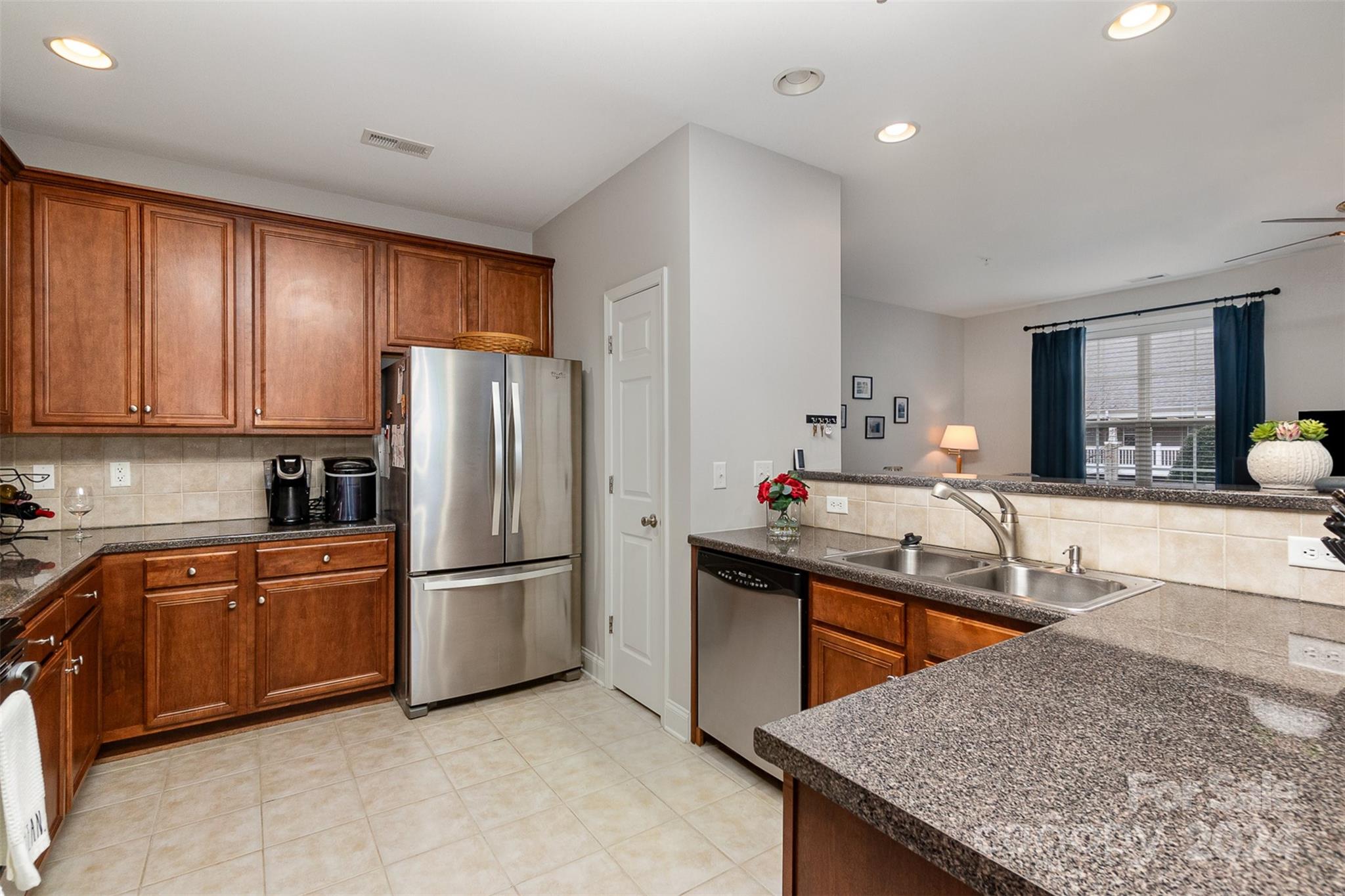 8653 Edinburgh Square Drive Cornelius, NC 28031 - Photo 2 of 22 a kitchen with stainless steel appliances granite countertop a sink stove and refrigerator