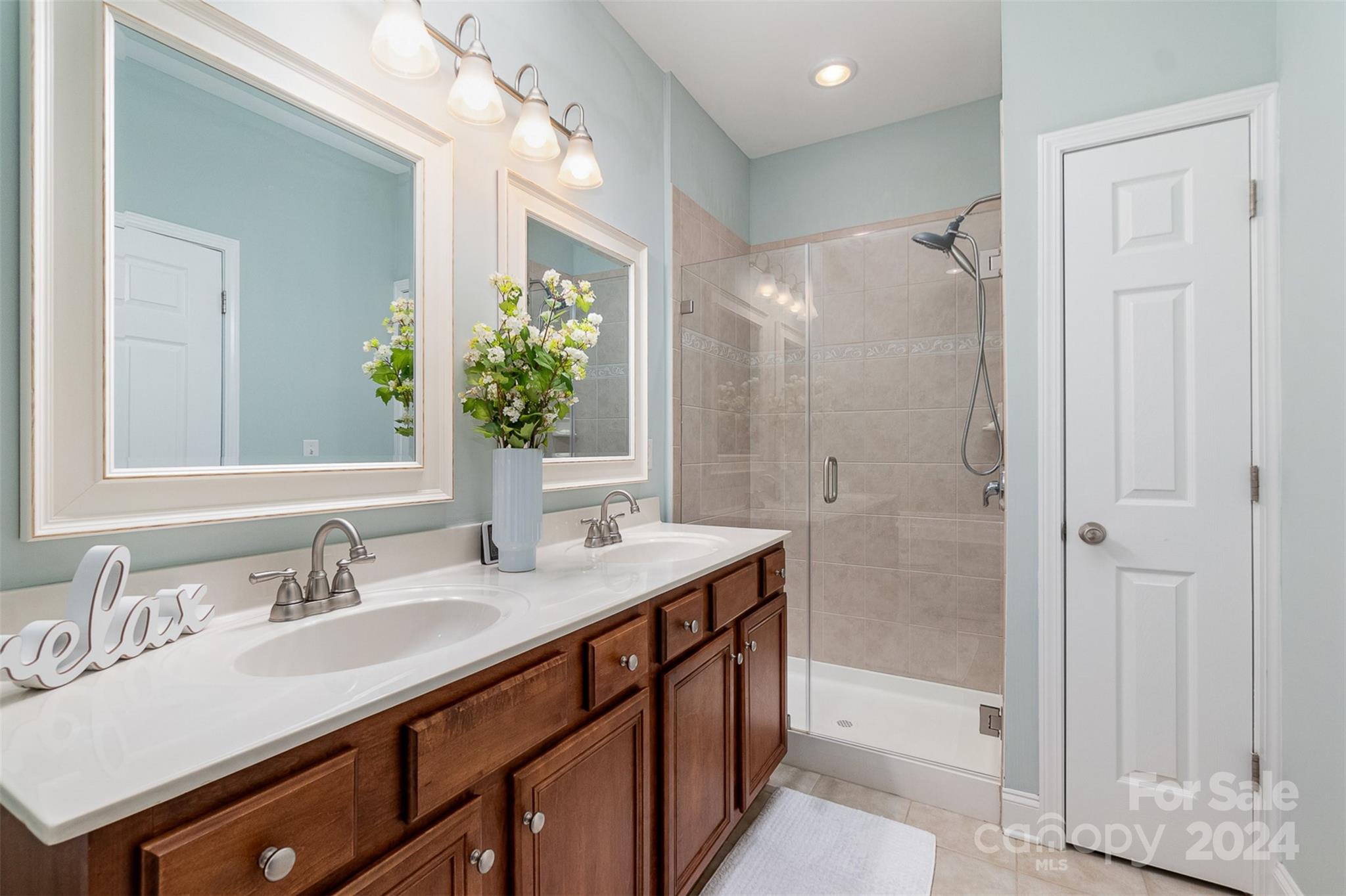 8653 Edinburgh Square Drive Cornelius, NC 28031 - Photo 8 of 22 a bathroom with a granite countertop sink mirror and a shower