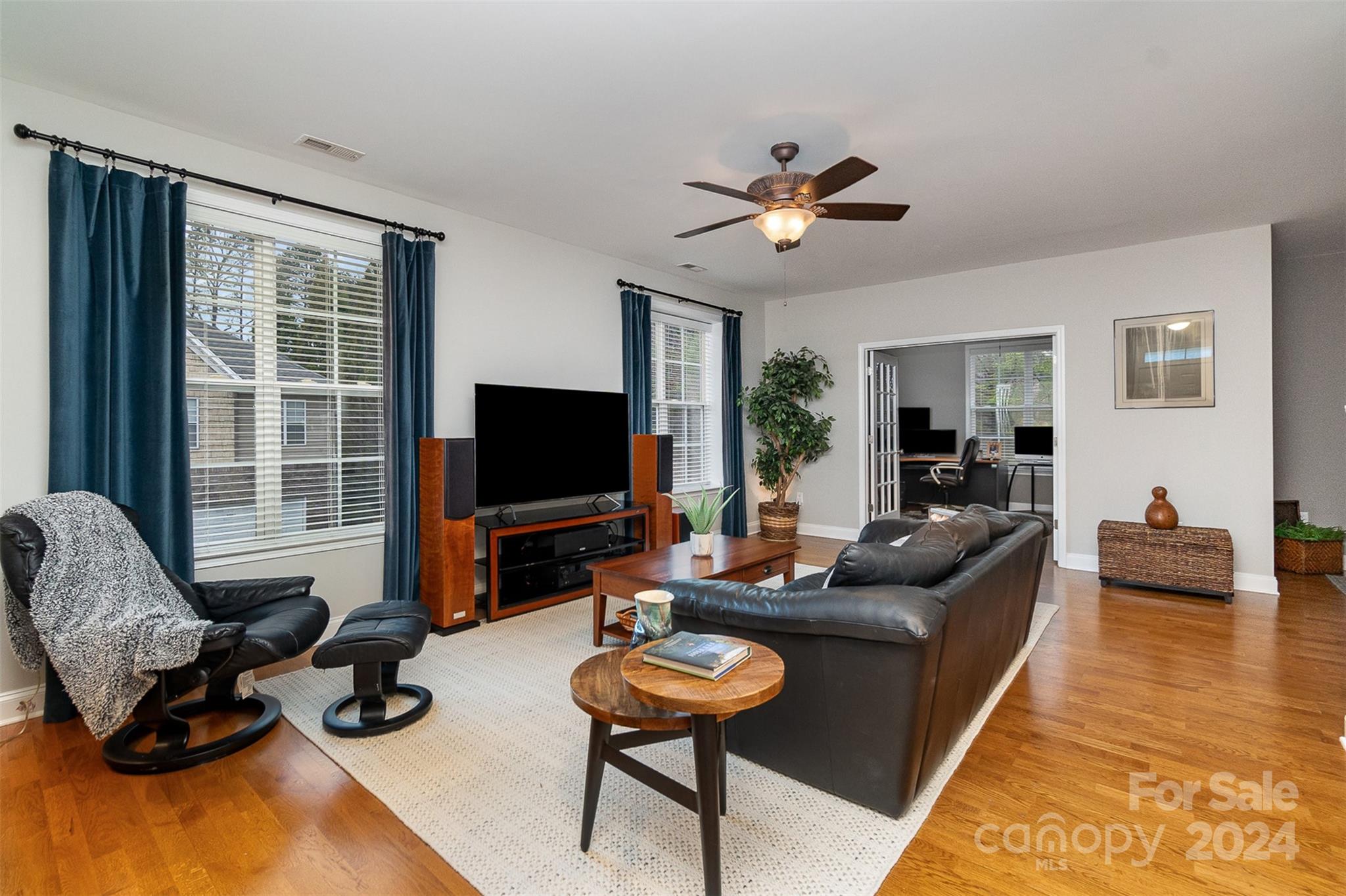 8653 Edinburgh Square Drive Cornelius, NC 28031 - Photo 10 of 22 a living room with furniture and a flat screen tv