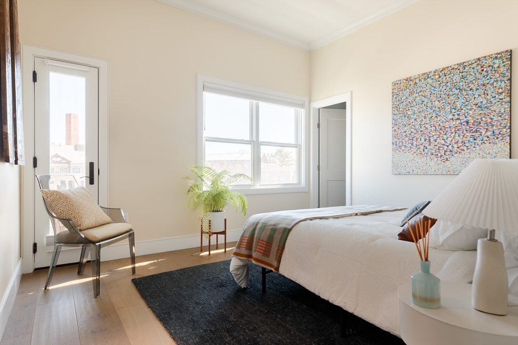 11 Tannery Brook Row, Unit 3 Somerville, MA 02144 - Photo 11 of 20 a bedroom with a bed and a chair