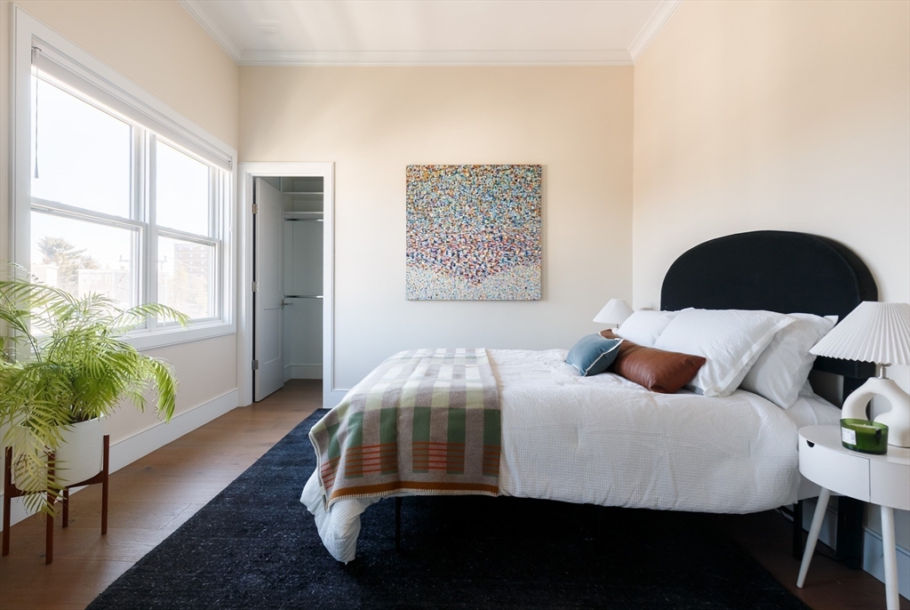 11 Tannery Brook Row, Unit 3 Somerville, MA 02144 - Photo 12 of 20 a bedroom with a bed and wooden floor